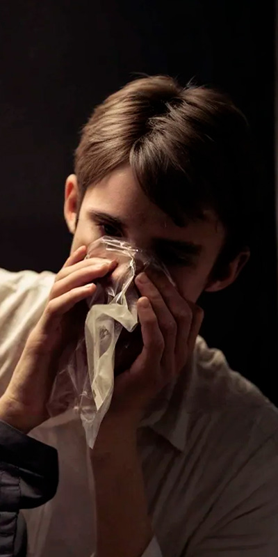 Мужчина дышит в кулек
